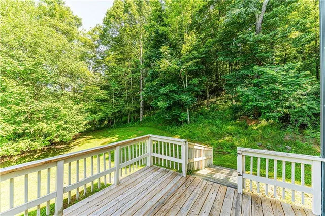 a front view of a house with plants and trees