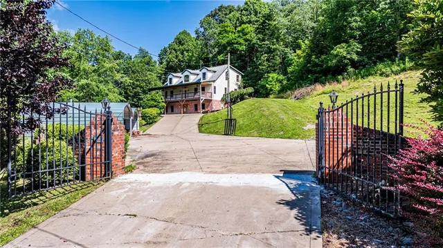 an aerial view of a house with a yard and lake view