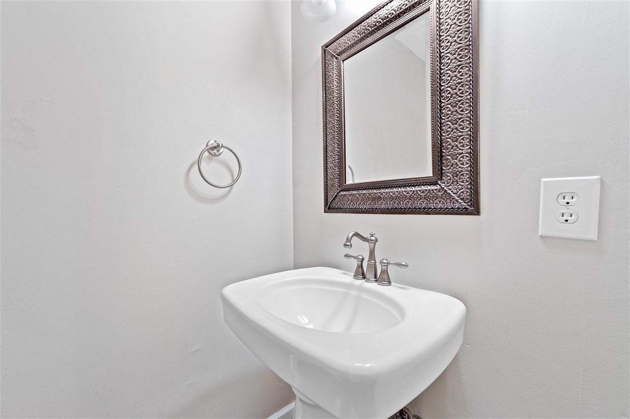 407 Brooks Avenue Raleigh, NC 27607 - Photo 17 of 30 a bathroom with a sink and a mirror