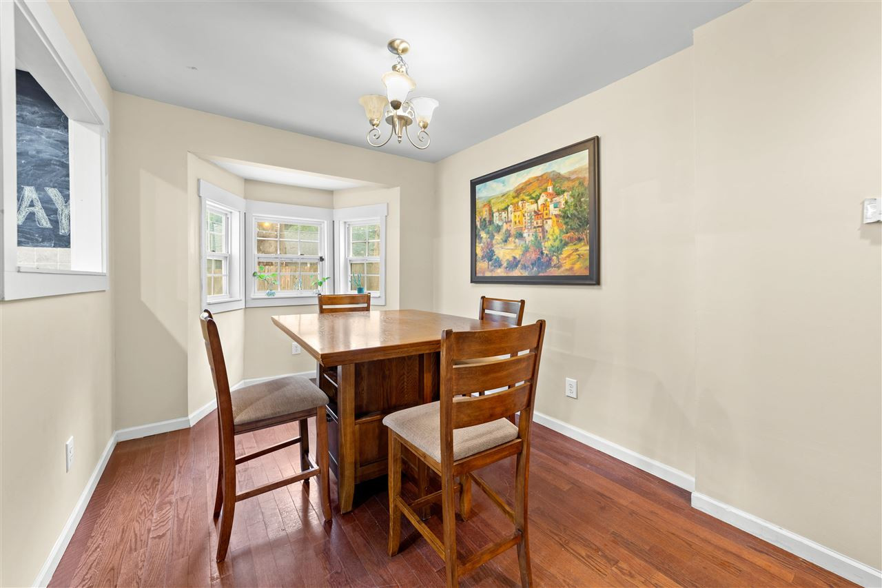 407 Brooks Avenue Raleigh, NC 27607 - Photo 18 of 30 a view of a dining room with furniture wooden floor and a chandelier