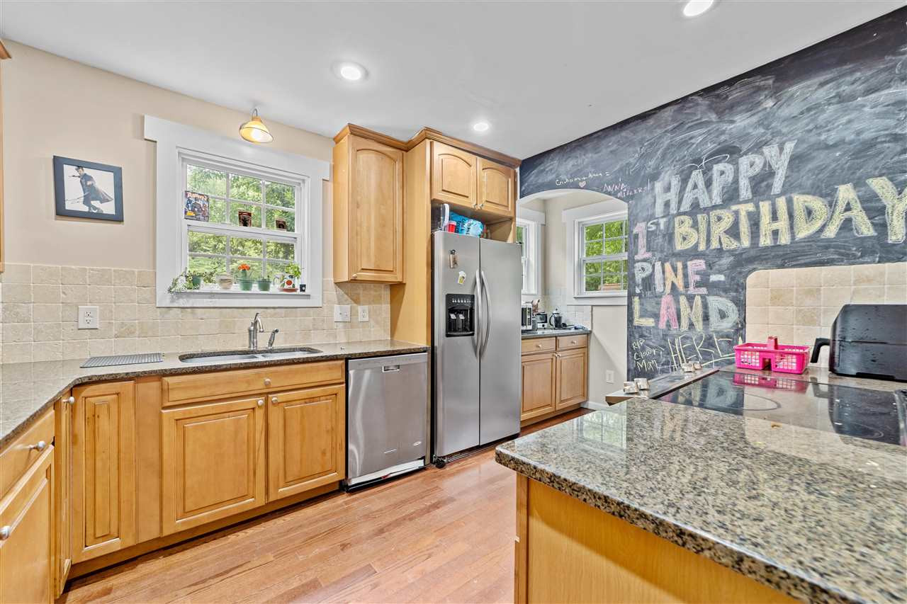 407 Brooks Avenue Raleigh, NC 27607 - Photo 20 of 30 a kitchen with stainless steel appliances granite countertop a sink stove and refrigerator