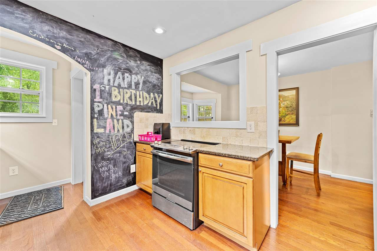 407 Brooks Avenue Raleigh, NC 27607 - Photo 21 of 30 a kitchen with granite countertop a stove and a refrigerator