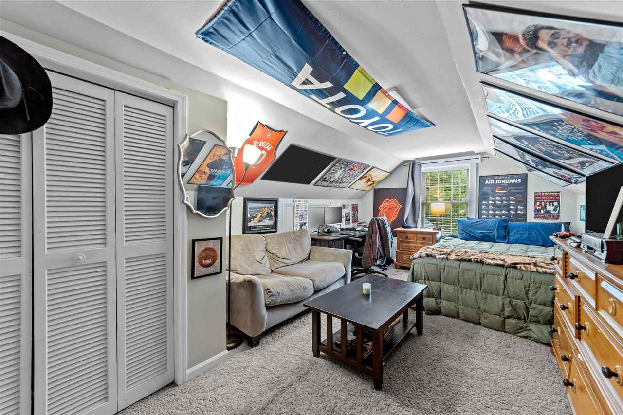 407 Brooks Avenue Raleigh, NC 27607 - Photo 29 of 30 a living room with furniture and a flat screen tv