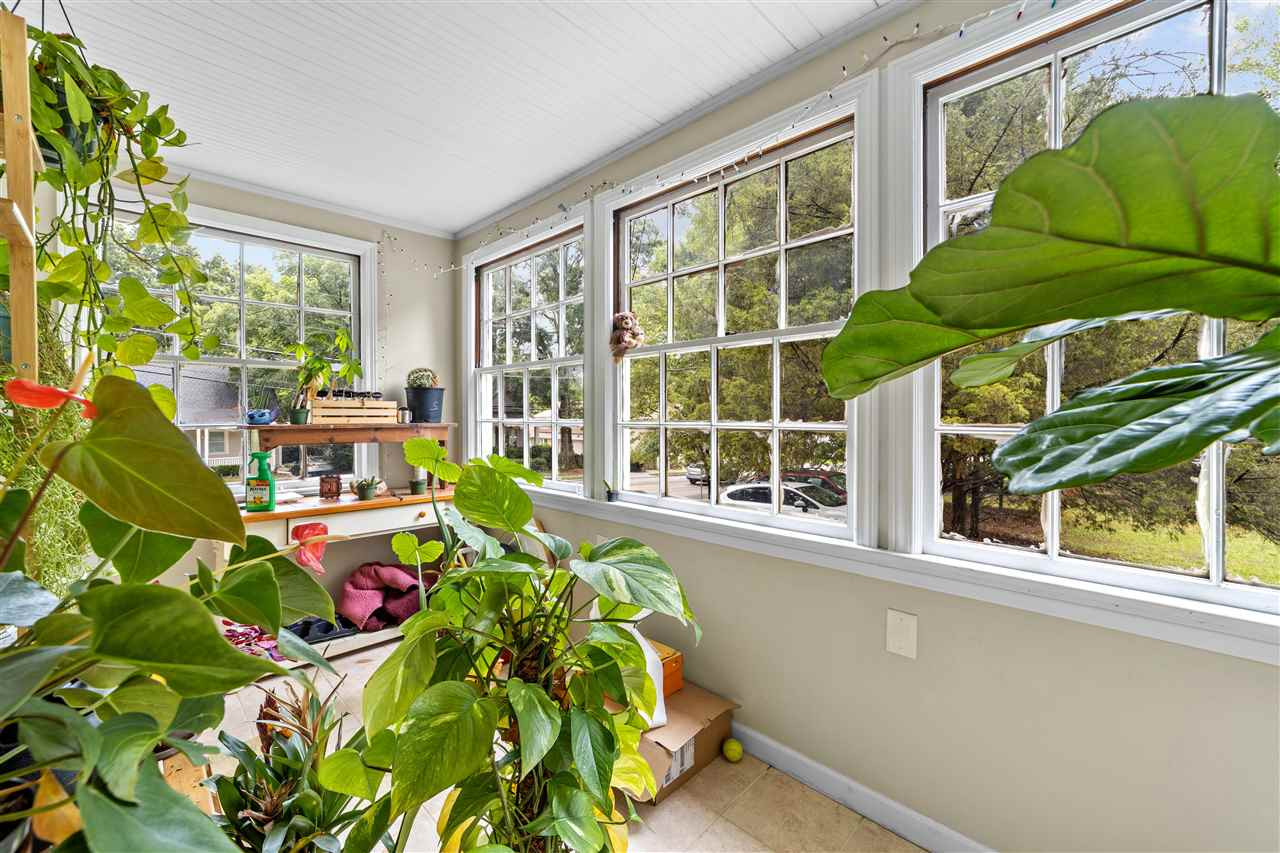 407 Brooks Avenue Raleigh, NC 27607 - Photo 10 of 30 a living room filled with furniture and a potted plant