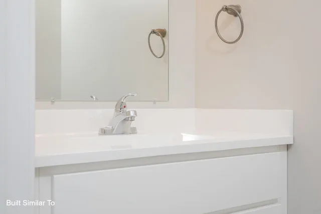 a bathroom with a sink and a window