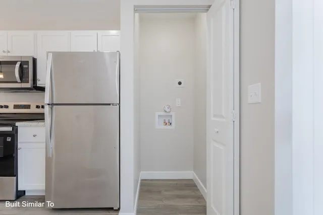 a white refrigerator freezer sitting in a kitchen