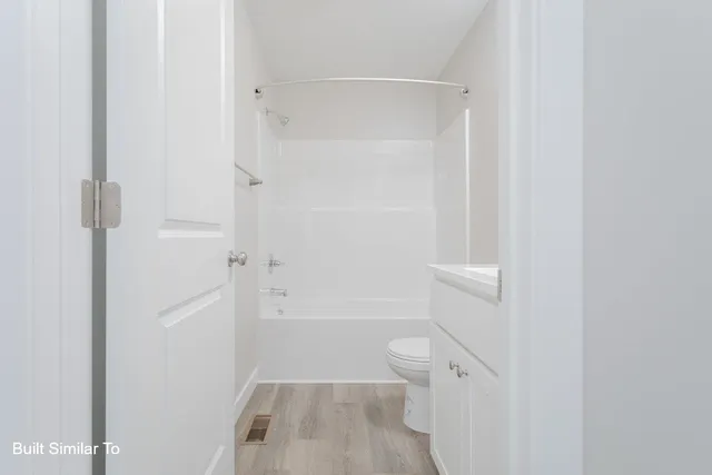 a bathroom with a sink toilet vanity and tub
