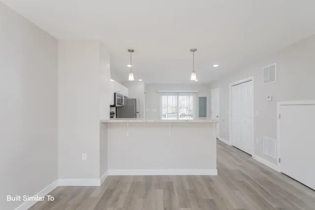 a view of kitchen with cabinets and wooden floor
