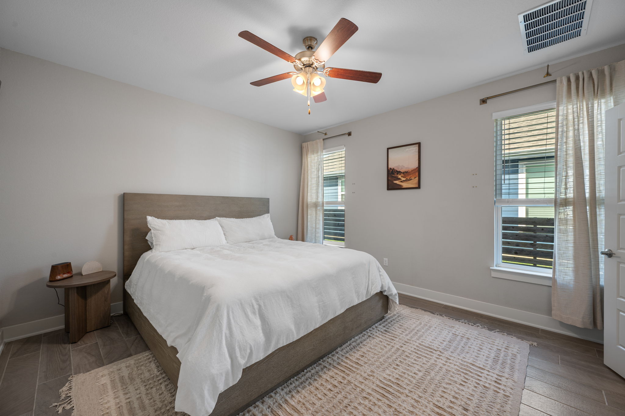 5409 Fox Wing Way Austin, TX 78747 - Photo 10 of 26 Relax in comfort within this well-lit bedroom featuring a ceiling fan and elegant tiled flooring.