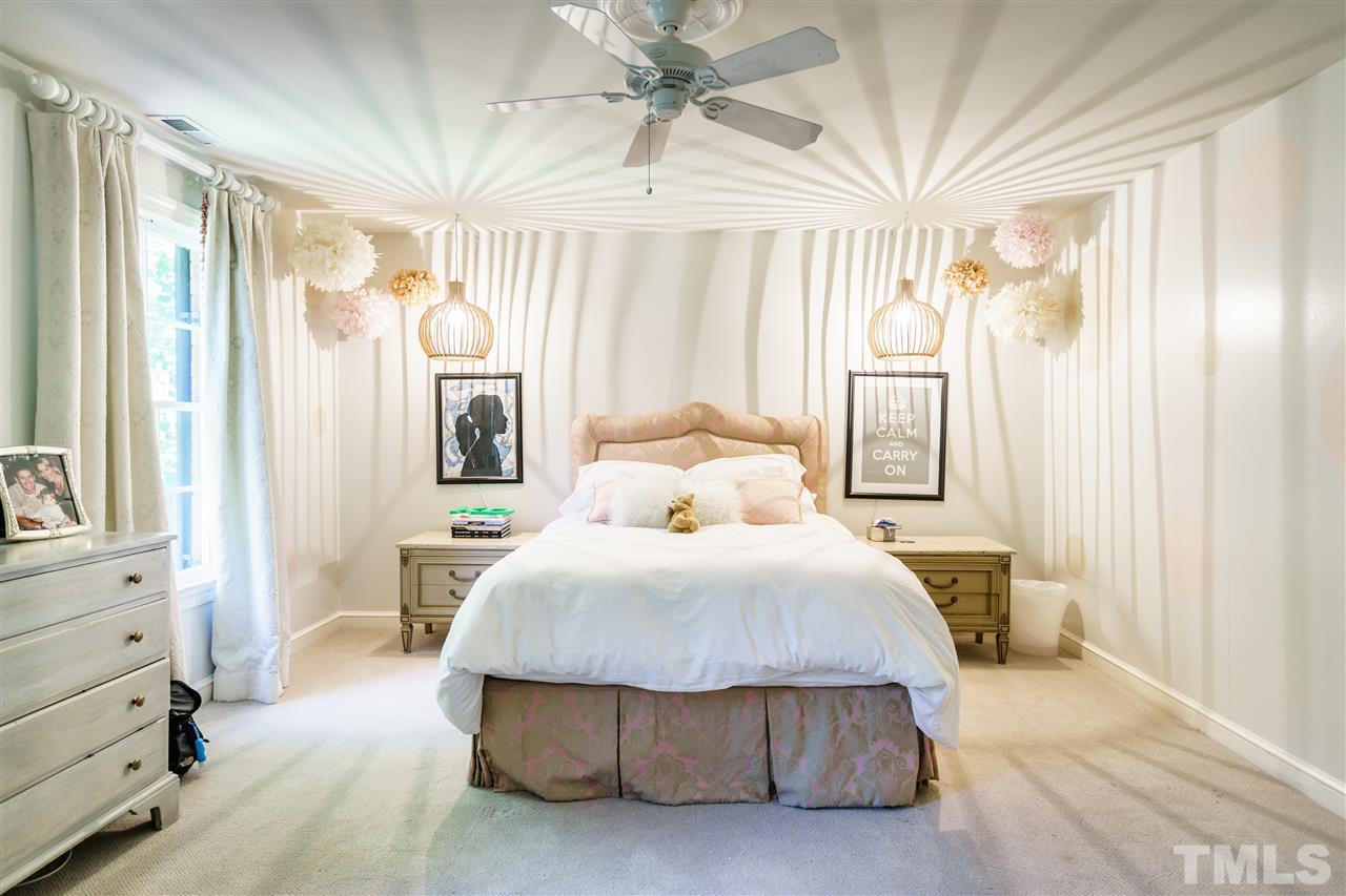 3300 Landor Road Raleigh, NC 27609 - Photo 13 of 25 a bedroom with a large bed and a chandelier