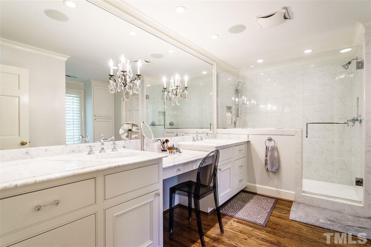 3300 Landor Road Raleigh, NC 27609 - Photo 16 of 25 a spacious bathroom with a double vanity sink a mirror and a shower