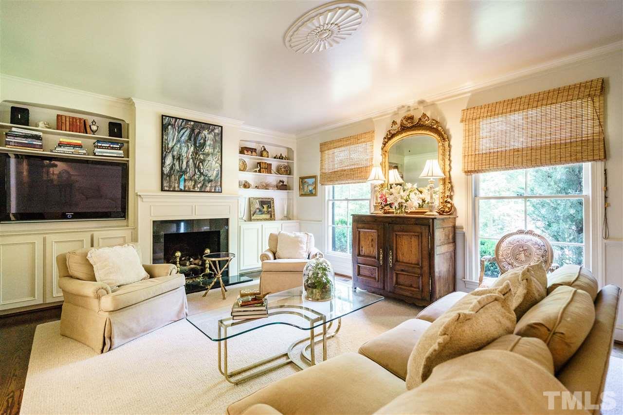 3300 Landor Road Raleigh, NC 27609 - Photo 4 of 25 a living room with furniture a fireplace and a flat screen tv