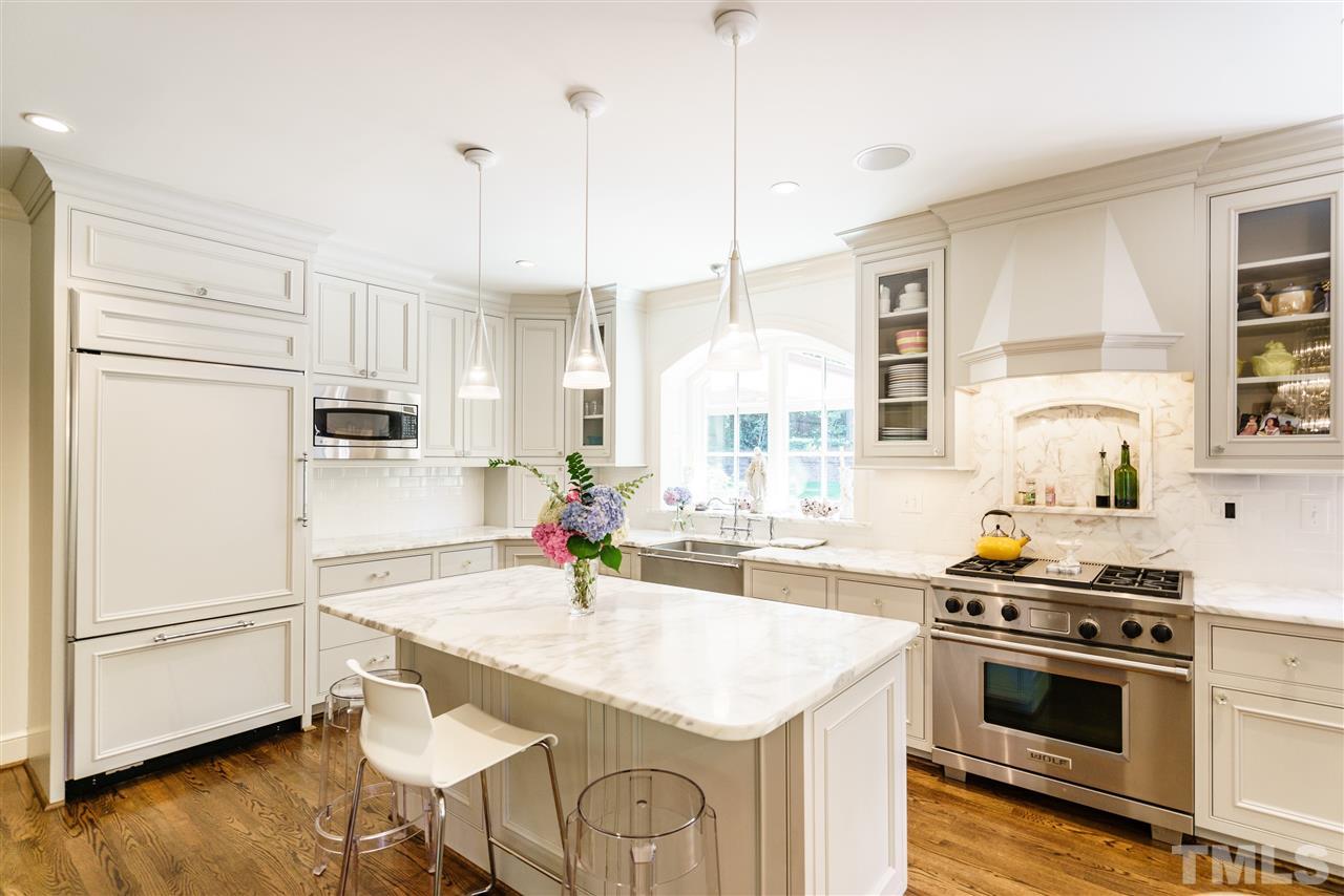3300 Landor Road Raleigh, NC 27609 - Photo 7 of 25 a kitchen with a stove a sink and a refrigerator