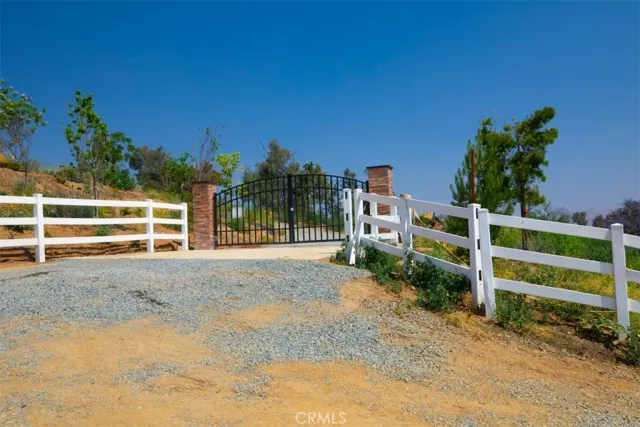 a view of a house with a yard and wooden fence