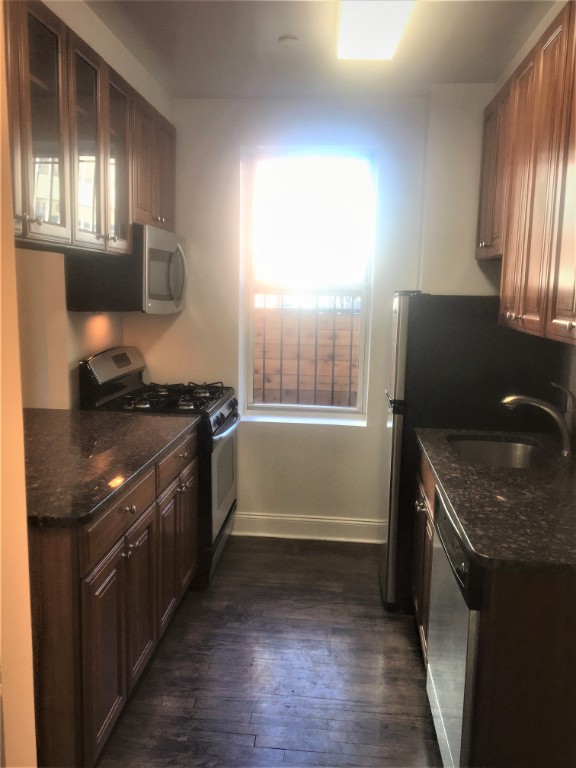 57 Sip Avenue, Unit 1A Jersey City, NJ 07306 - Photo 2 of 8 a kitchen with granite countertop a stove and a sink