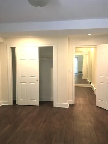 an empty room with windows and closet