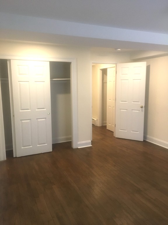 57 Sip Avenue, Unit 1A Jersey City, NJ 07306 - Photo 7 of 8 an empty room with windows and closet