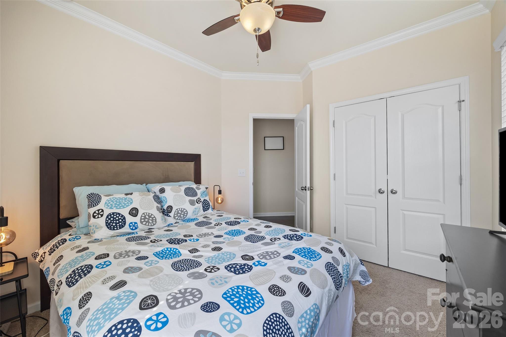 327 Hawks Creek Parkway Fort Mill, SC 29708 - Photo 20 of 48 a bedroom with a large bed and a chandelier