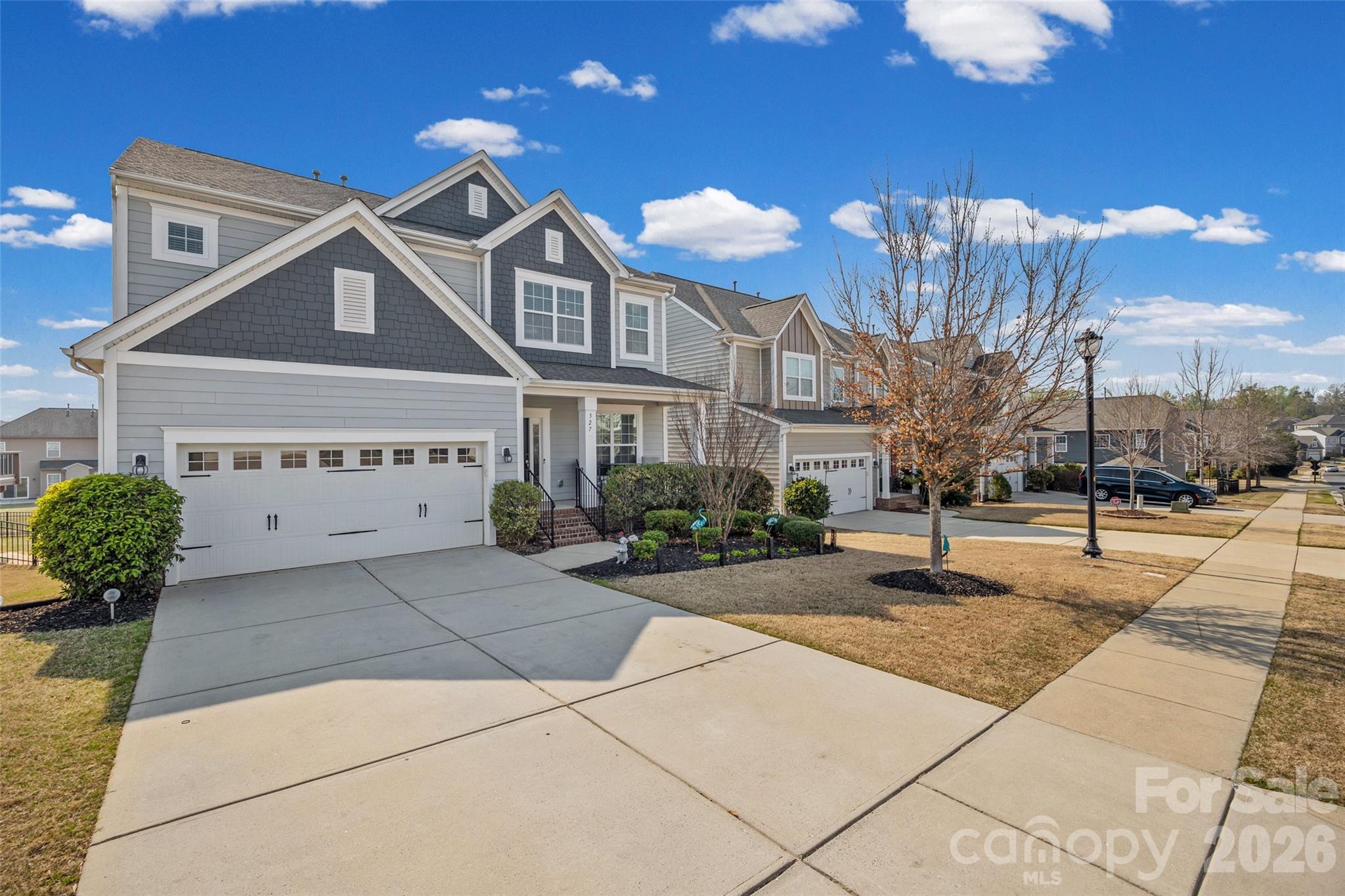 327 Hawks Creek Parkway Fort Mill, SC 29708 - Photo 2 of 48 a front view of a house with a yard and potted plants