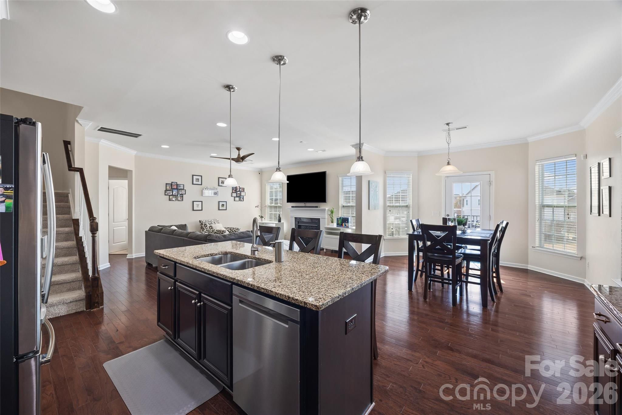 327 Hawks Creek Parkway Fort Mill, SC 29708 - Photo 8 of 48 a kitchen with stainless steel appliances granite countertop a stove top oven a refrigerator a dining table and chairs with wooden floor