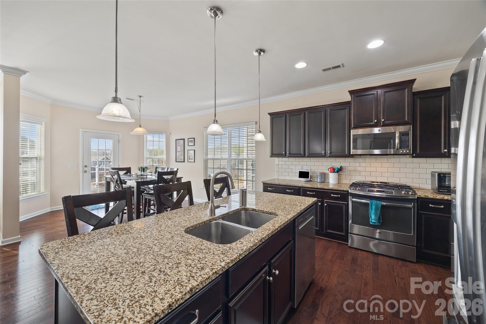 327 Hawks Creek Parkway Fort Mill, SC 29708 - Photo 9 of 48 a kitchen with stainless steel appliances granite countertop a sink a stove and a wooden floors