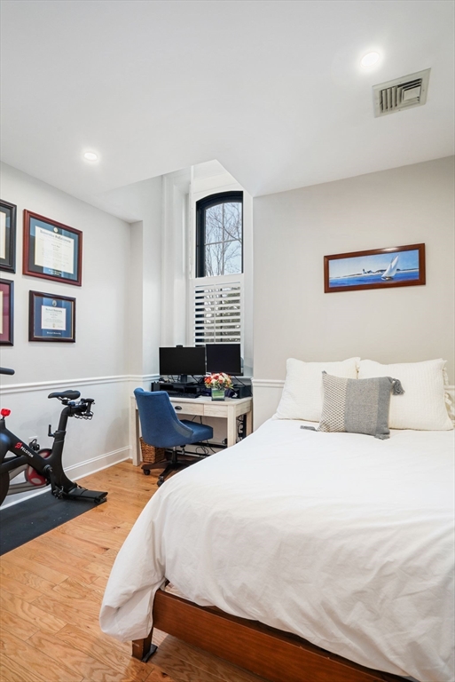 68 Baldwin Street, Unit 1 Boston, MA 02129 - Photo 11 of 19 a bedroom with a bed and wooden floor