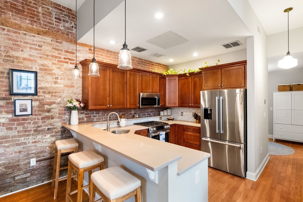 68 Baldwin Street, Unit 1 Boston, MA 02129 - Photo 7 of 19 a kitchen with a sink a counter space appliances and cabinets