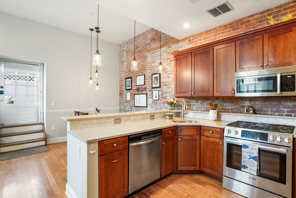 68 Baldwin Street, Unit 1 Boston, MA 02129 - Photo 8 of 19 a kitchen with a sink stove and microwave