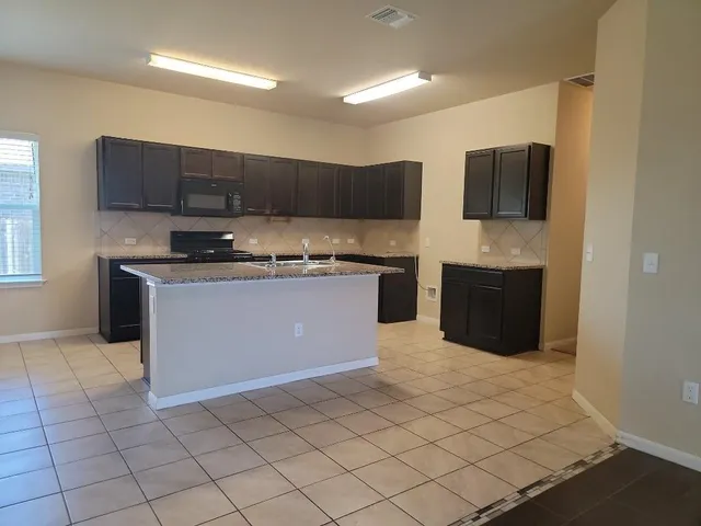 a view of a kitchen with a dishwasher and a large window