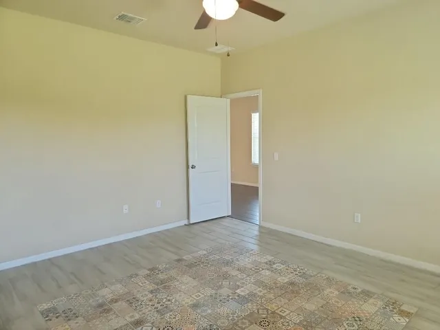 a view of kitchen with granite countertop cabinets and window