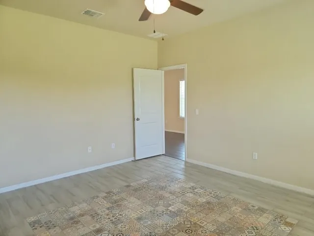 a view of kitchen with granite countertop cabinets and window