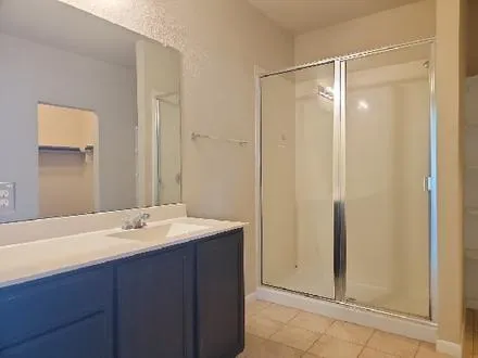 a view of a room with a ceiling fan and a window