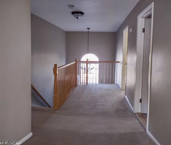 a view of entryway with wooden floor and windows