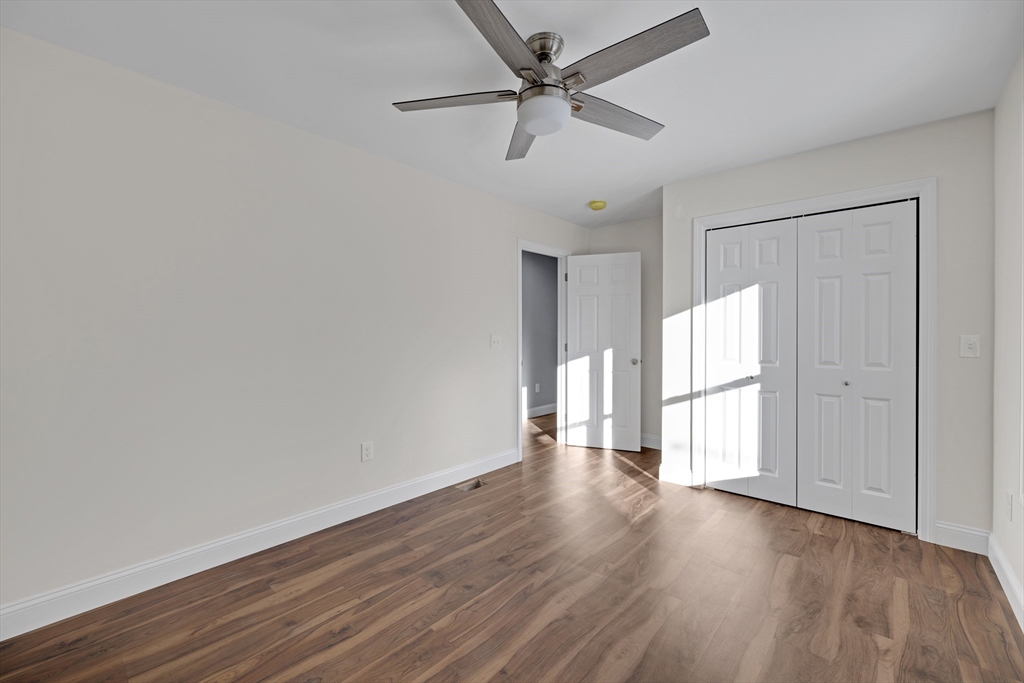 132 Kibbe Road East Longmeadow, MA 01028 - Photo 25 of 32 an empty room with wooden floor fan and windows
