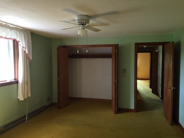 130 Athol Road Orange, MA 01364 - Photo 15 of 20 an empty room with chandelier fan and windows