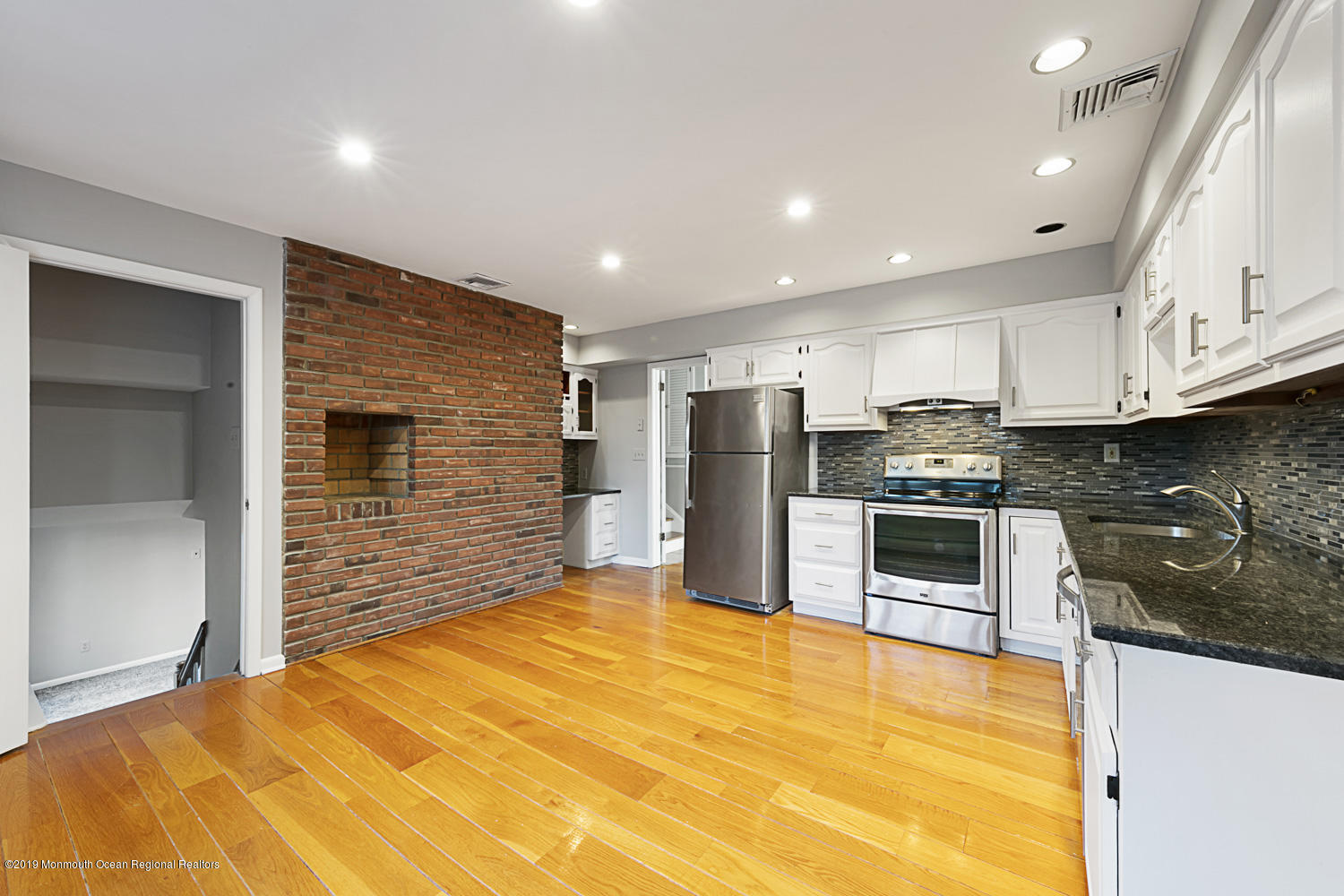 2 Old Farm Road Colts Neck, NJ 07722 - Photo 14 of 56 a large kitchen with stainless steel appliances a large counter top a stove and a refrigerator