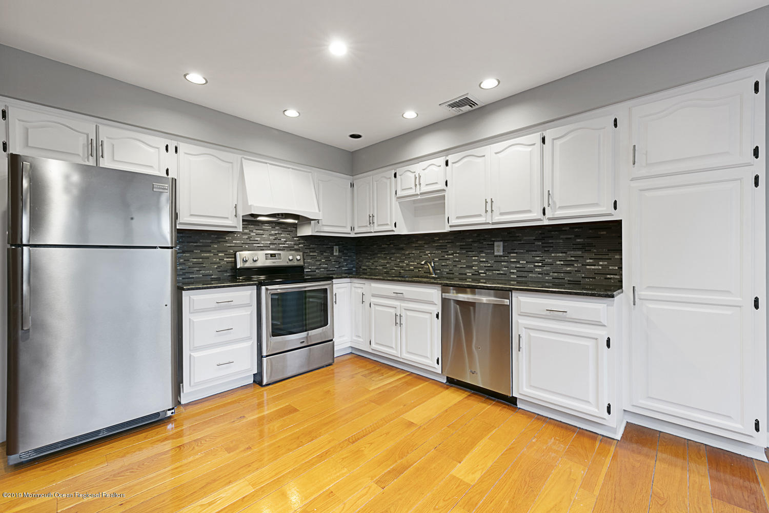 2 Old Farm Road Colts Neck, NJ 07722 - Photo 16 of 56 a kitchen with granite countertop white cabinets and white appliances