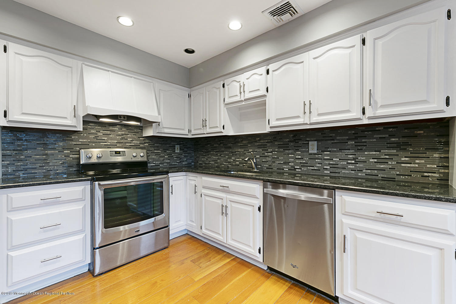 2 Old Farm Road Colts Neck, NJ 07722 - Photo 17 of 56 a kitchen with granite countertop white cabinets stainless steel appliances and a sink