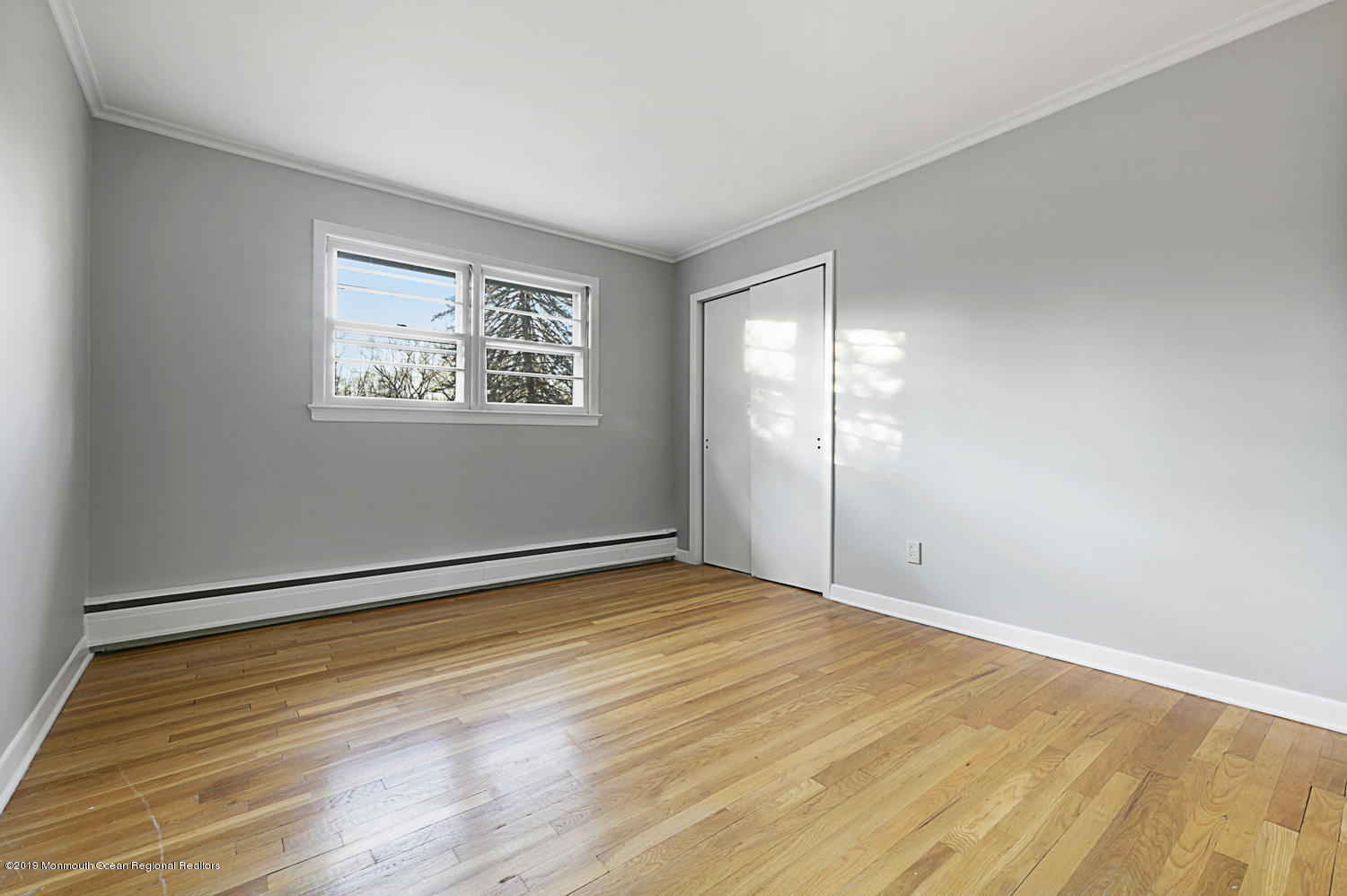 2 Old Farm Road Colts Neck, NJ 07722 - Photo 41 of 56 a view of an empty room with wooden floor and a window