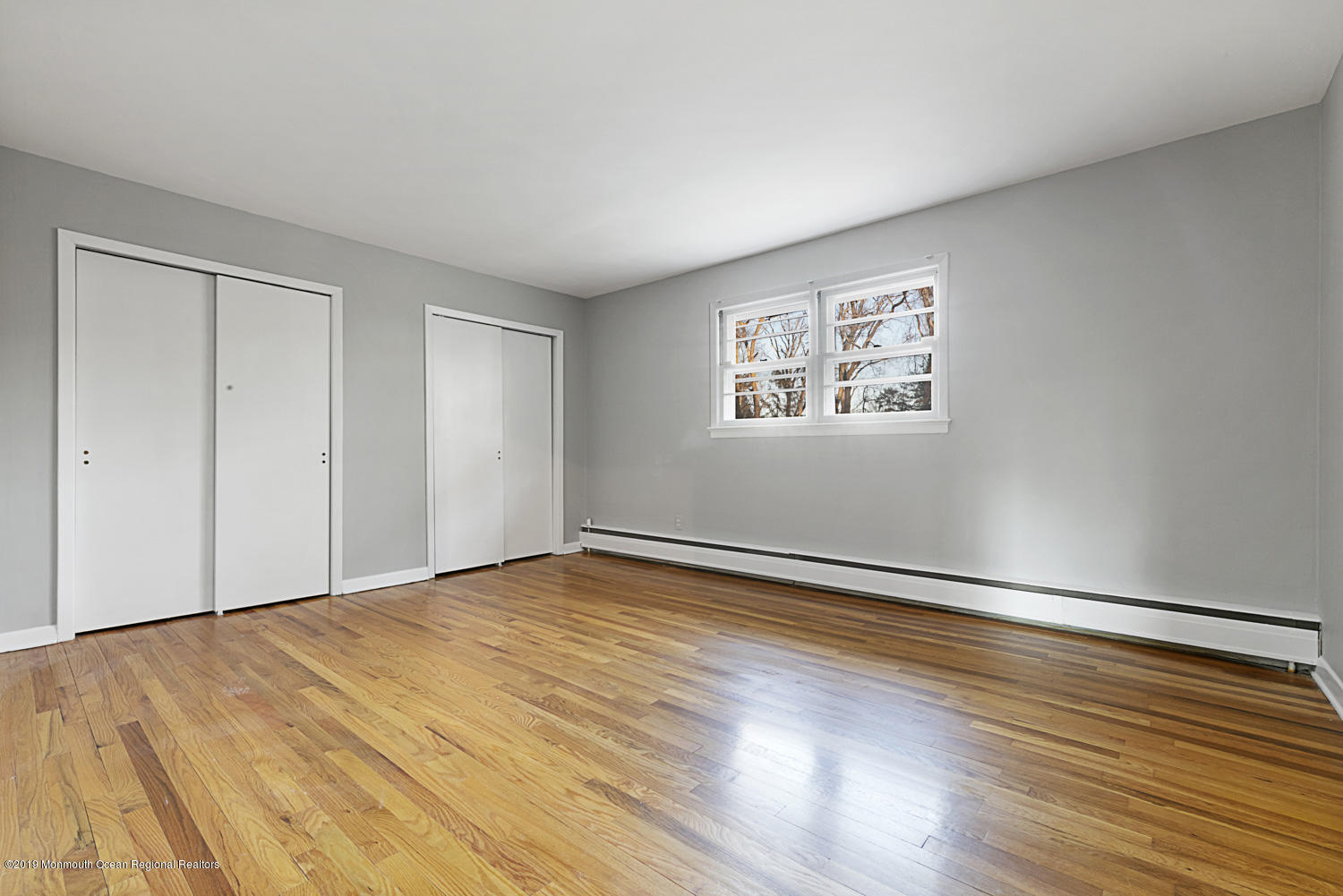 2 Old Farm Road Colts Neck, NJ 07722 - Photo 42 of 56 a view of an empty room with wooden floor and a window
