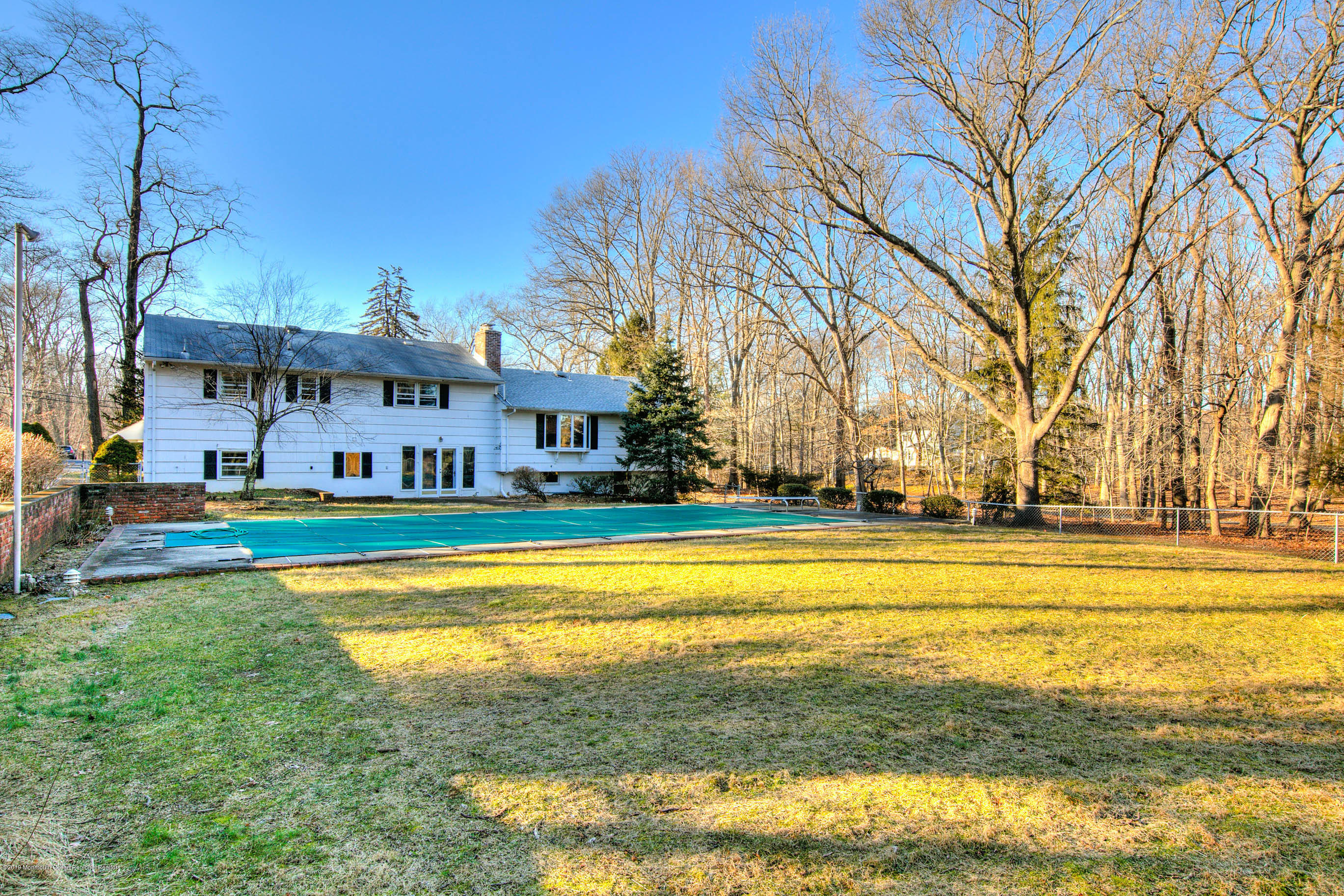 2 Old Farm Road Colts Neck, NJ 07722 - Photo 48 of 56 a view of swimming pool with outdoor seating and house in the background