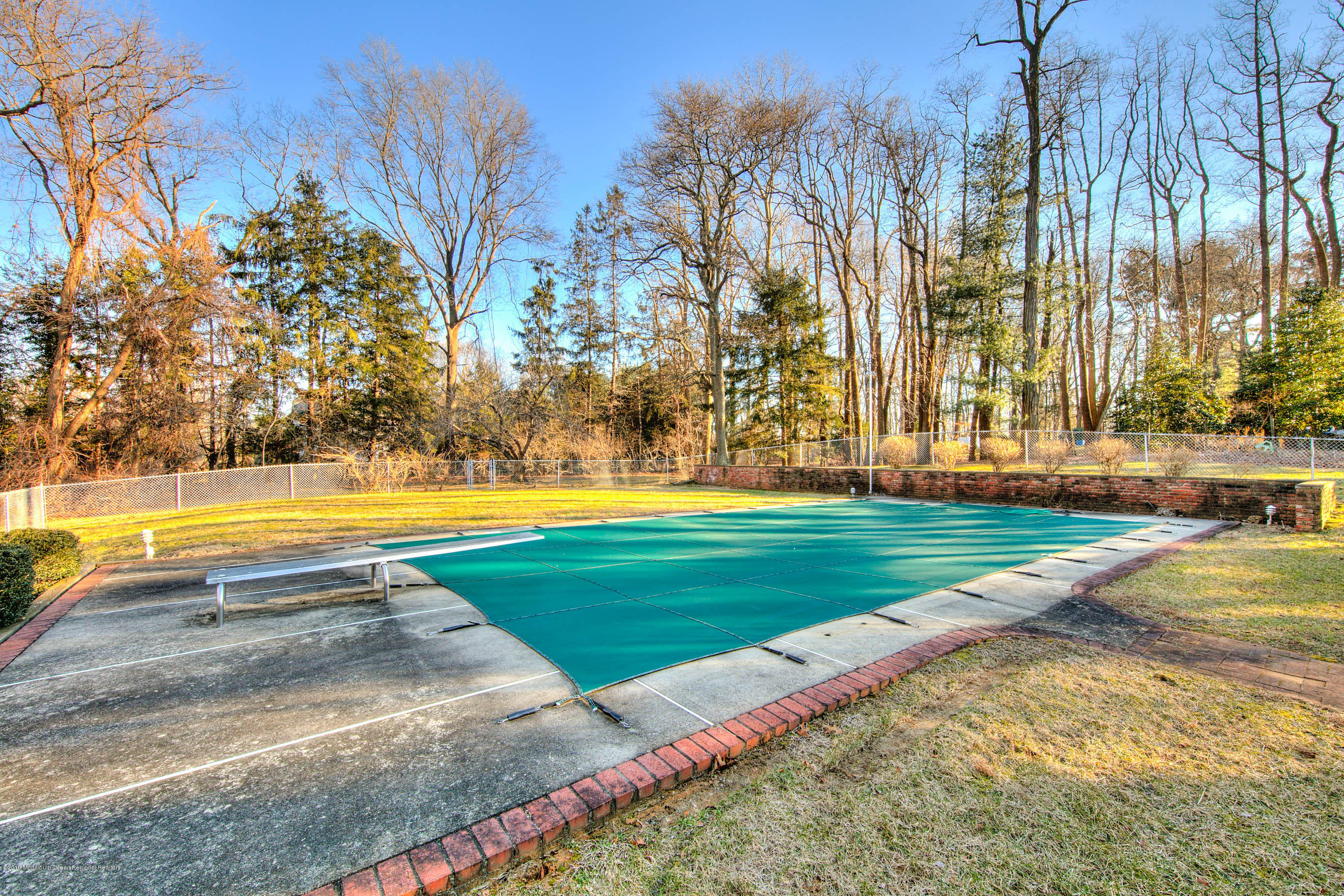 2 Old Farm Road Colts Neck, NJ 07722 - Photo 51 of 56 a view of a swimming pool with a yard and palm trees