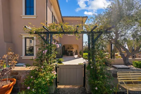 a front view of a house with a yard and a fountain