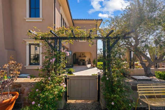 a front view of a house with a yard and a fountain