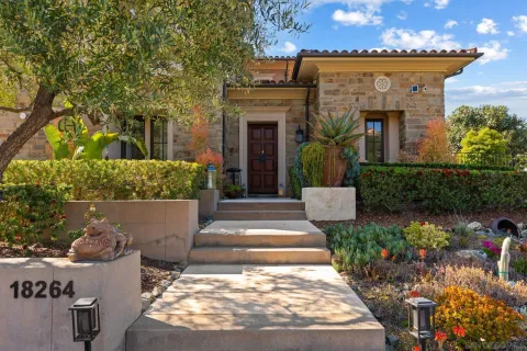 a front view of a house with a garden