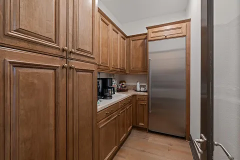 a kitchen with stainless steel appliances granite countertop a refrigerator and a sink