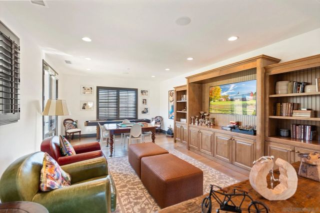 a living room with furniture a rug and a bookshelf