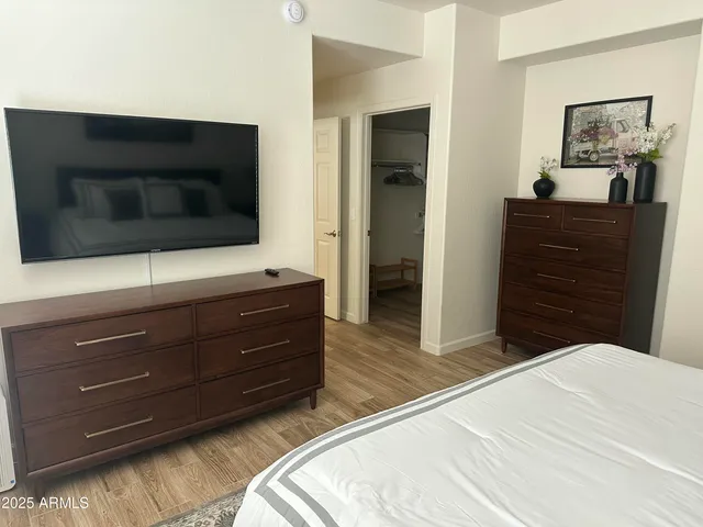 a en suite bathroom with a granite countertop sink and a mirror