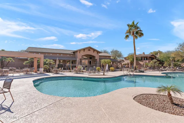 a view of a swimming pool with an outdoor seating