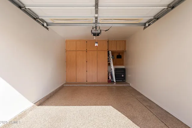 a large white kitchen with a stove a sink dishwasher and a refrigerator with wooden floor